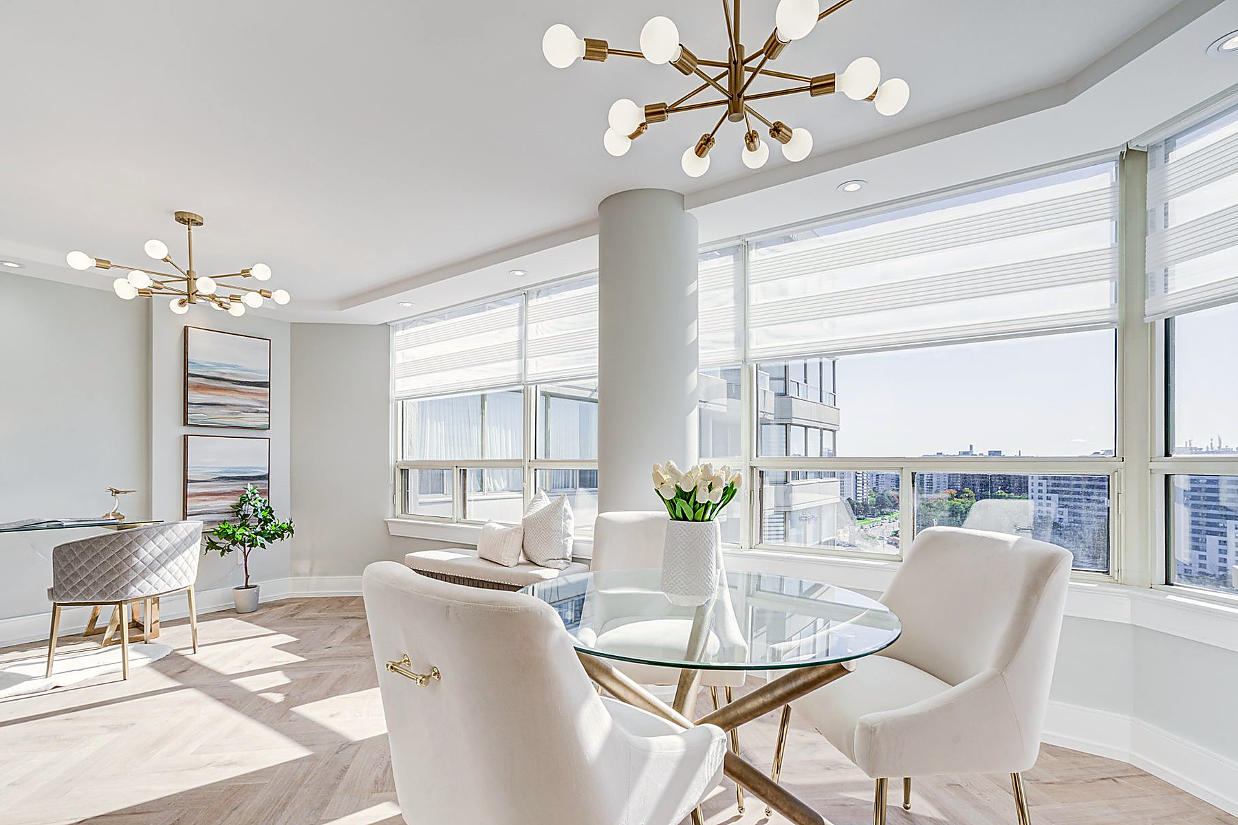 Professionally staged condo dining area with a city view